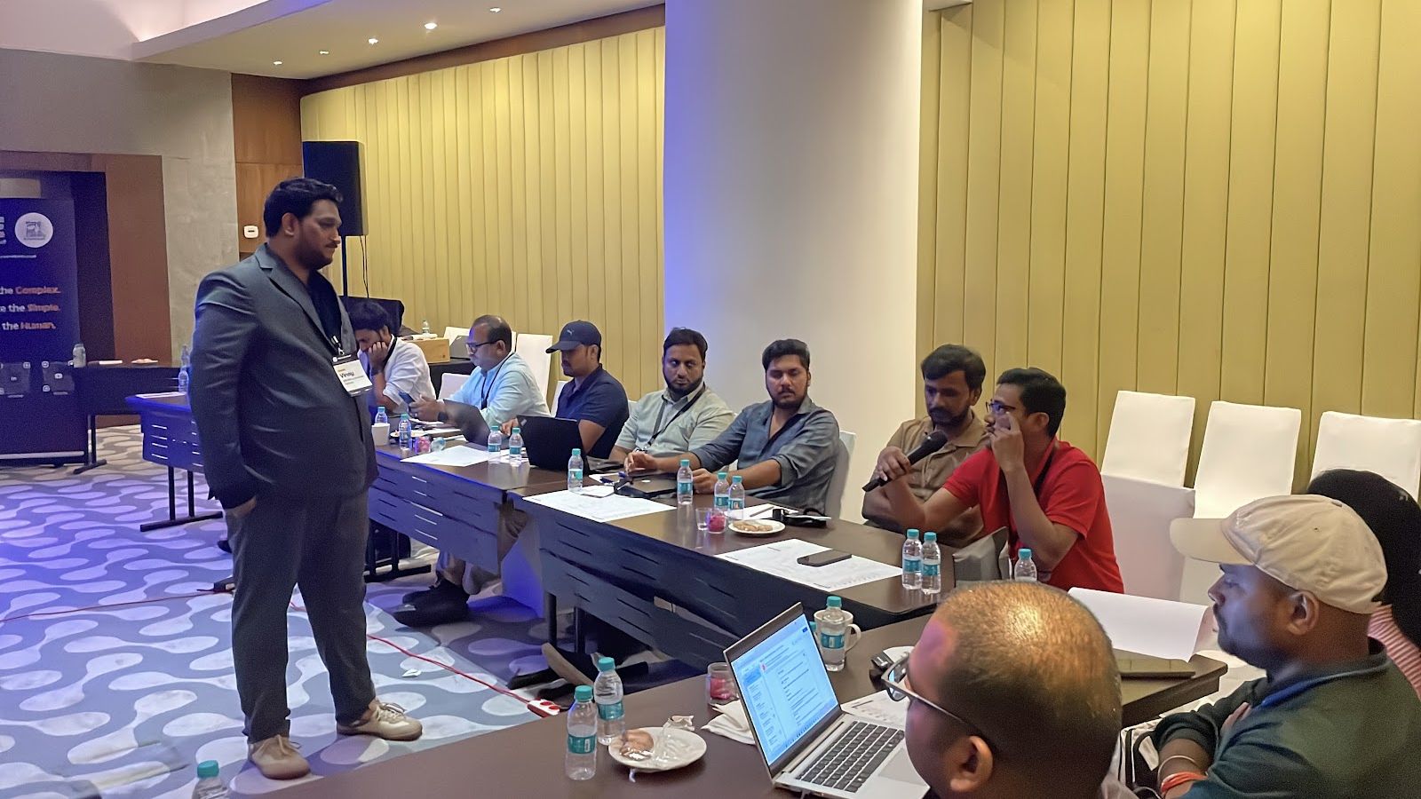 A host talking to the room while attendees work on their laptops